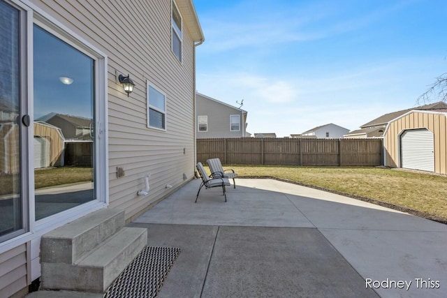 view of patio featuring an outdoor structure, a storage unit, and fence