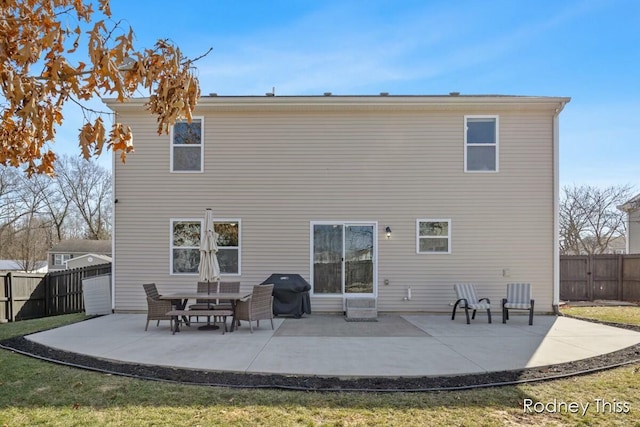 rear view of property featuring a patio area and fence