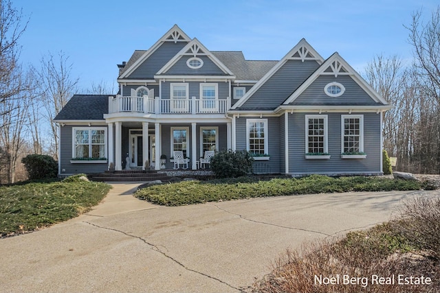 view of front of property with a porch and a balcony