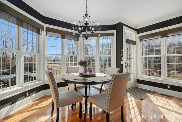 sunroom with visible vents and a chandelier