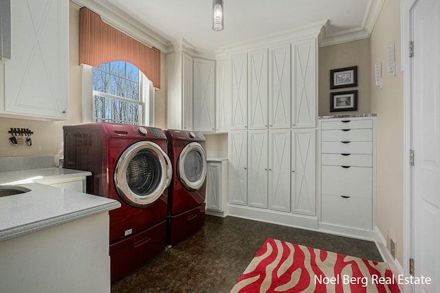 laundry room featuring visible vents, cabinet space, washer and dryer, and ornamental molding