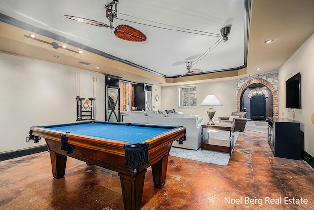 game room with billiards, baseboards, arched walkways, finished concrete floors, and a raised ceiling