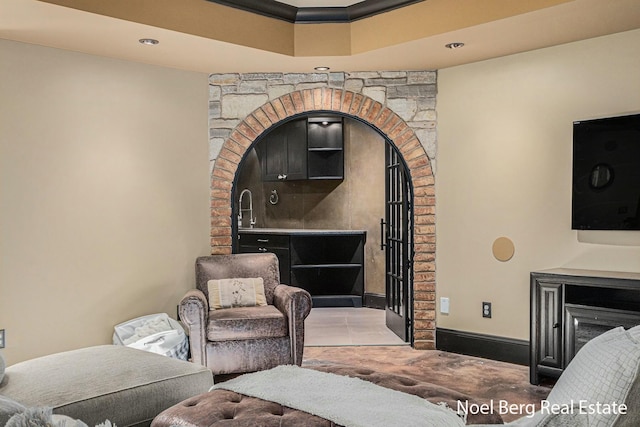 living room featuring a fireplace and baseboards