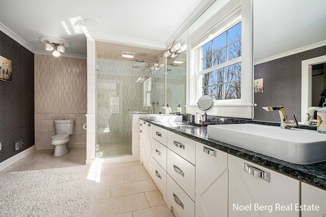 bathroom with a sink, ornamental molding, tile patterned floors, and wallpapered walls