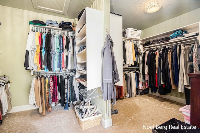 walk in closet featuring attic access