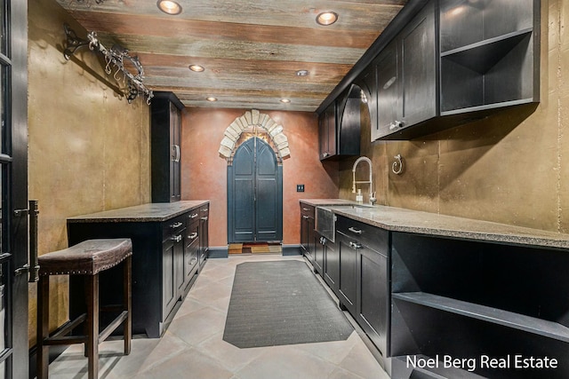 kitchen featuring open shelves, wooden ceiling, recessed lighting, and a sink