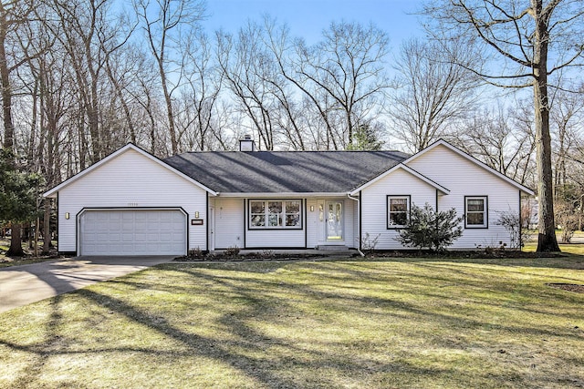 ranch-style home with a chimney, an attached garage, concrete driveway, and a front yard