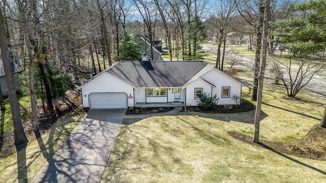 view of front of property with a front yard, an attached garage, concrete driveway, and a shingled roof