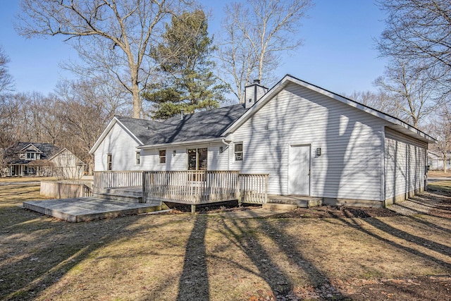 back of house with a wooden deck and a chimney