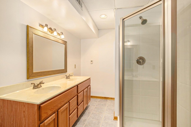 full bathroom with a sink, visible vents, double vanity, and a shower stall