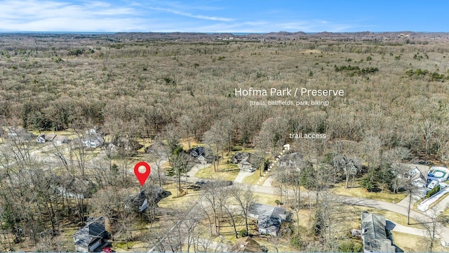 drone / aerial view featuring a wooded view