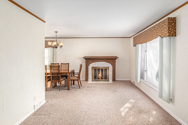 living room with a notable chandelier, crown molding, carpet, and a premium fireplace