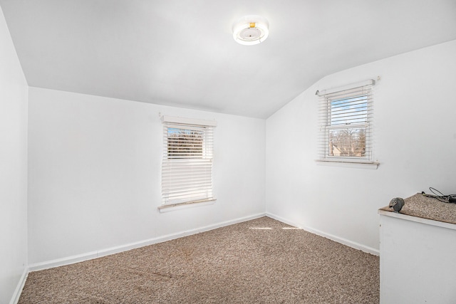 bonus room with lofted ceiling, baseboards, and carpet floors