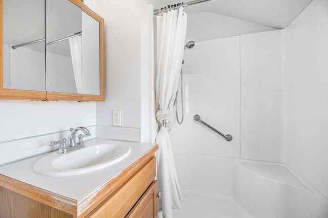 bathroom with curtained shower and vanity