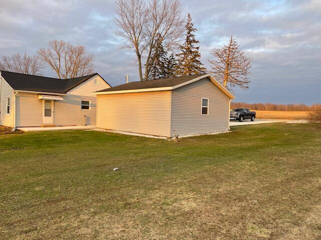 view of side of property with a yard