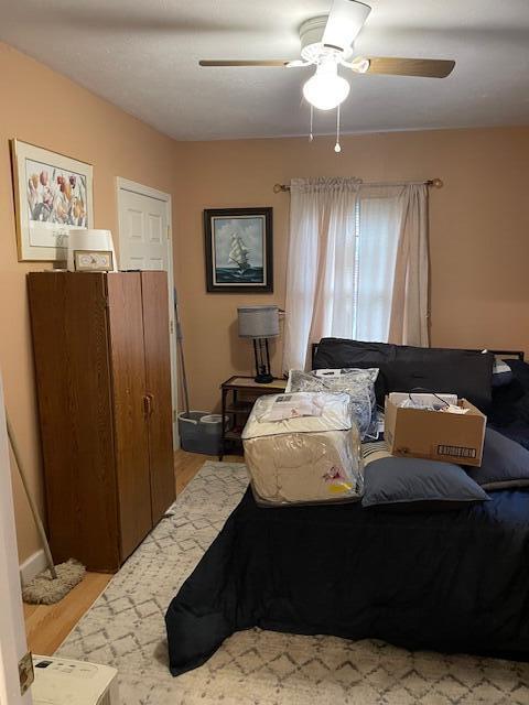 bedroom with ceiling fan and light wood-style floors