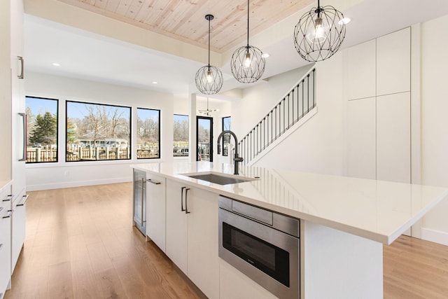 1 N Bailey Ave # 1, South Haven, MI 49090 - kitchen with a chandelier, a sink, light wood-style floors, modern cabinets, and wooden ceiling