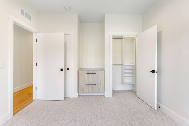 1 N Bailey Ave # 1, South Haven, MI 49090 - unfurnished bedroom with baseboards, light carpet, and a closet