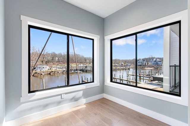 1 N Bailey Ave # 1, South Haven, MI 49090 - empty room featuring a water view, baseboards, and wood finished floors
