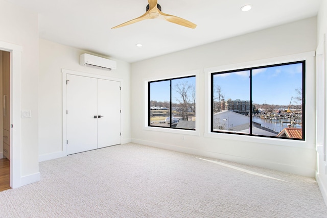 1 N Bailey Ave # 1, South Haven, MI 49090 - unfurnished bedroom with a wall mounted AC, carpet, baseboards, recessed lighting, and a closet