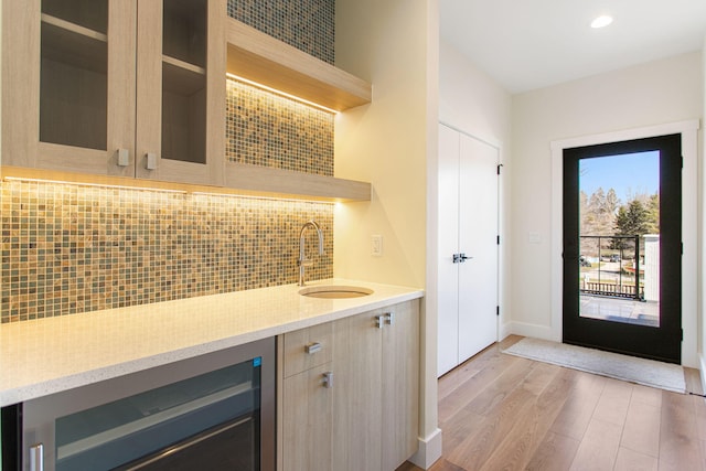 1 N Bailey Ave # 1, South Haven, MI 49090 - entrance foyer featuring bar with sink, beverage cooler, light wood-style flooring, baseboards, and recessed lighting