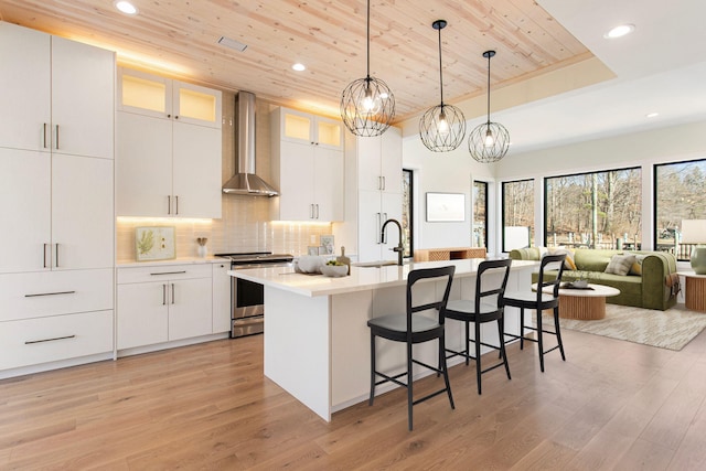 1 N Bailey Ave # 1, South Haven, MI 49090 - kitchen featuring gas range, wall chimney exhaust hood, a sink, wood ceiling, and a chandelier