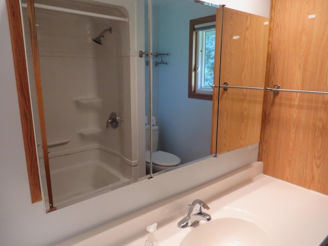 full bathroom with vanity, toilet, and walk in shower