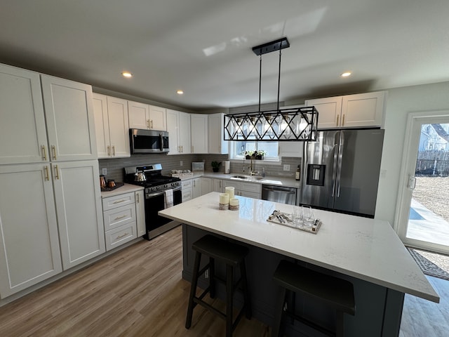 520 E Evelyn Ave, Hazel Park, MI 48030 - kitchen with light wood-style flooring, plenty of natural light, tasteful backsplash, and appliances with stainless steel finishes