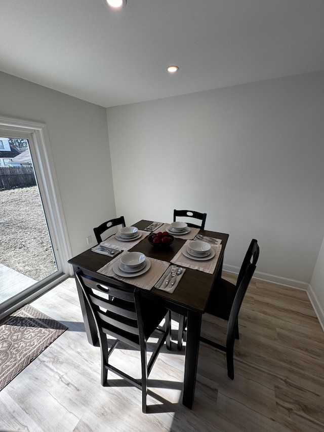 dining area featuring recessed lighting, baseboards, and wood finished floors