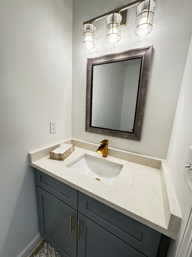 bathroom with baseboards and vanity