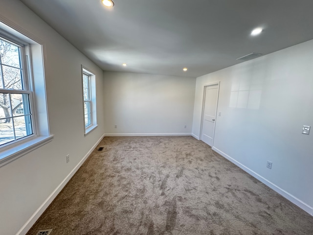 carpeted empty room with visible vents, recessed lighting, and baseboards