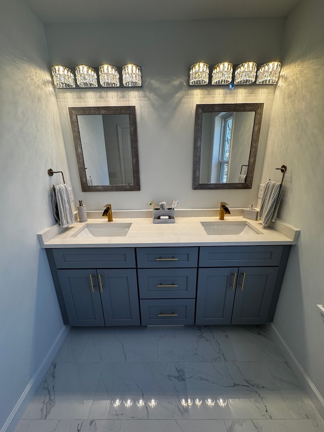 full bath with a sink, baseboards, and marble finish floor