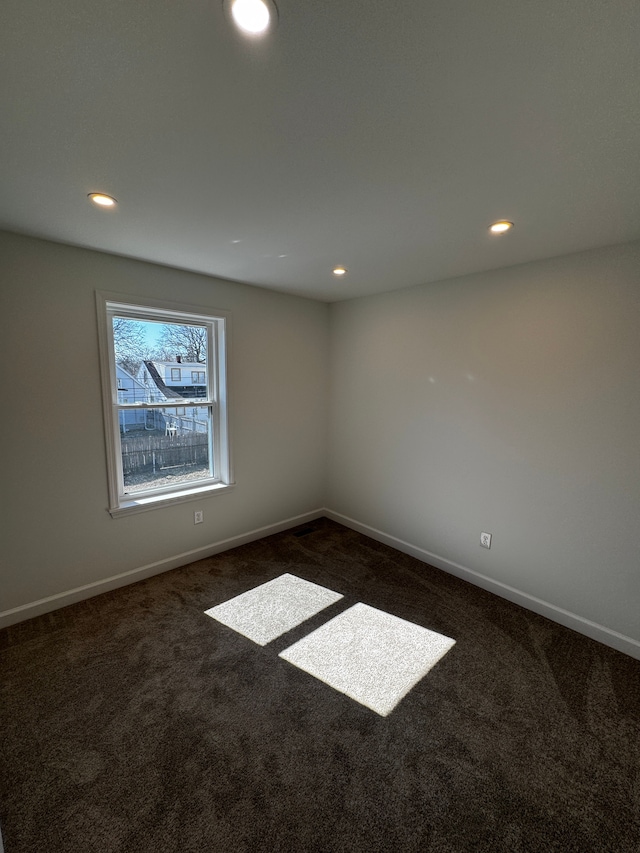 unfurnished room featuring recessed lighting, baseboards, and dark colored carpet