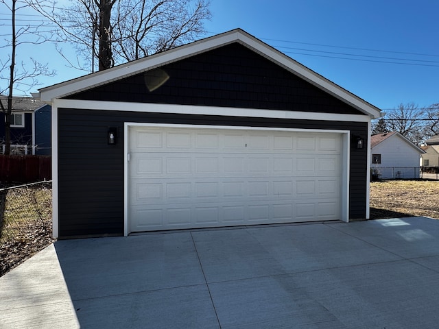 detached garage featuring fence