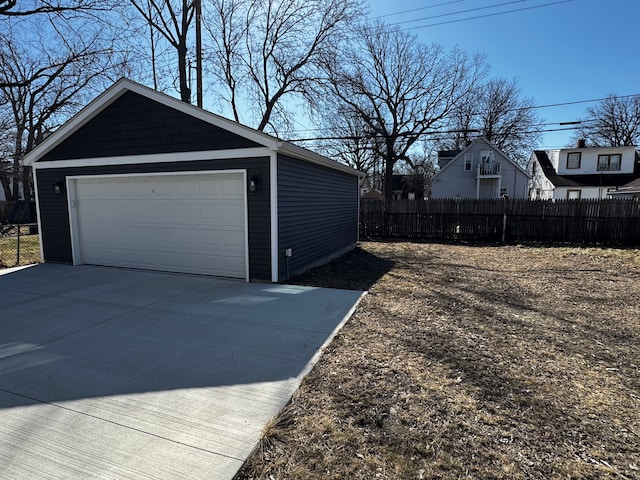 detached garage featuring fence