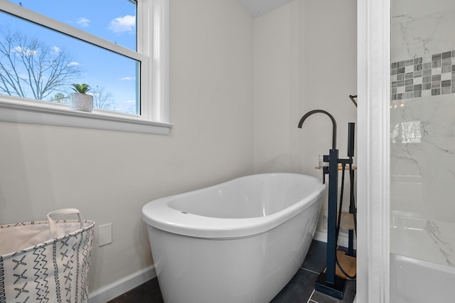 full bathroom with baseboards and a soaking tub