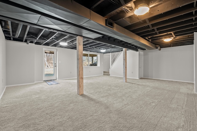 below grade area with stairs, baseboards, and carpet floors