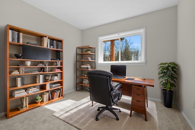 home office with light colored carpet and baseboards