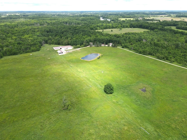 drone / aerial view featuring a forest view