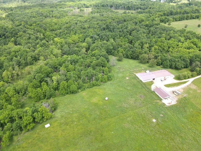 birds eye view of property with a forest view