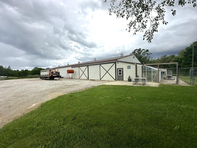 view of outbuilding with an outdoor structure and fence