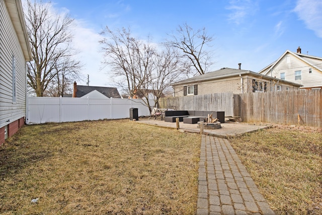 view of yard with an outdoor living space with a fire pit, a fenced backyard, and a patio area