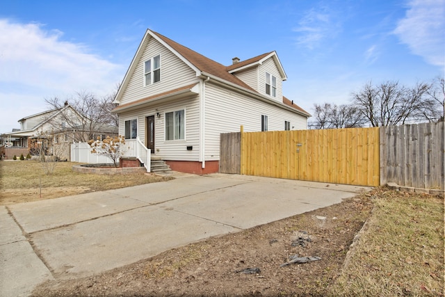 view of side of property with a gate and fence