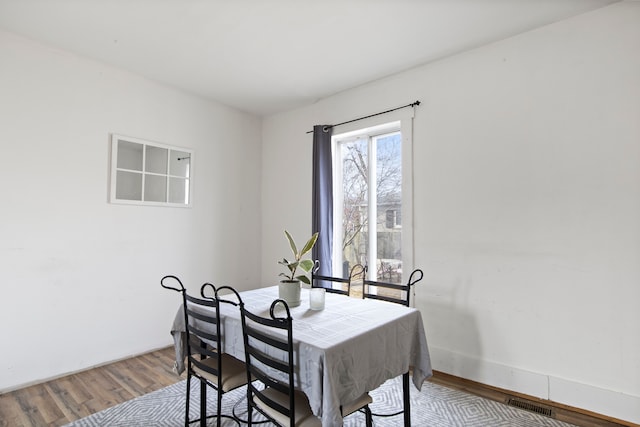 dining room featuring visible vents and wood finished floors