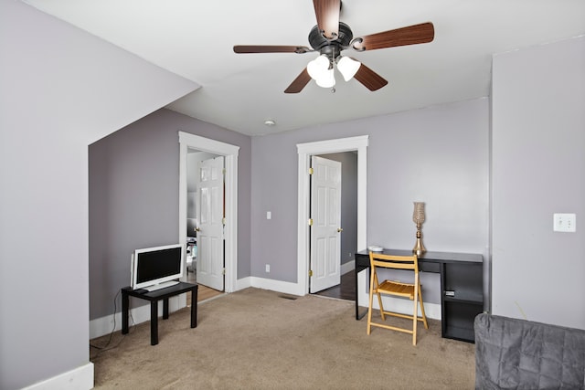 sitting room featuring baseboards, carpet, and a ceiling fan