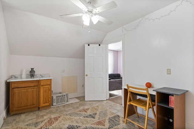 home office featuring lofted ceiling and ceiling fan