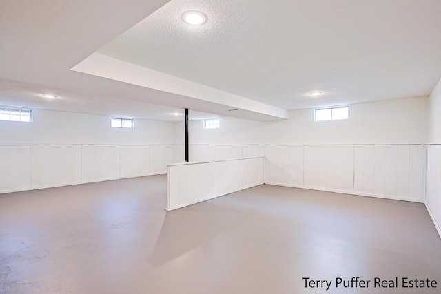 basement featuring a textured ceiling