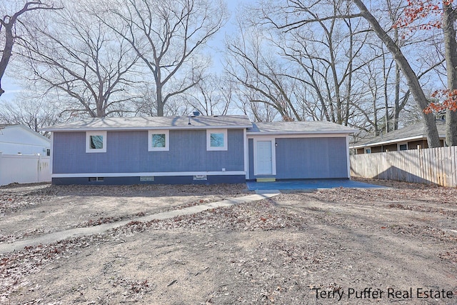 view of front of house featuring fence and crawl space