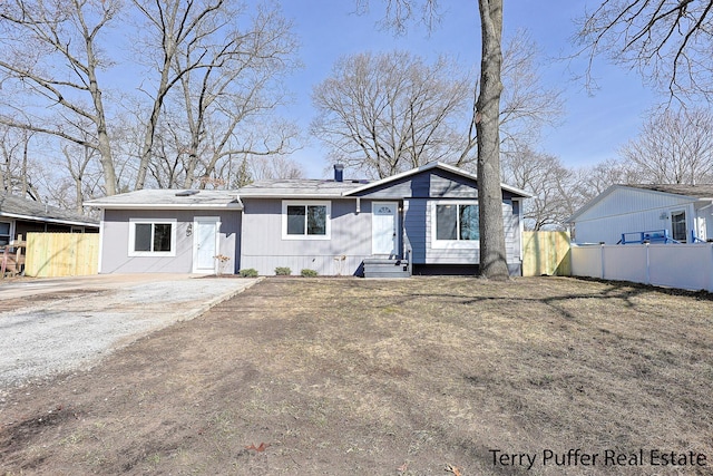 view of front of home featuring fence