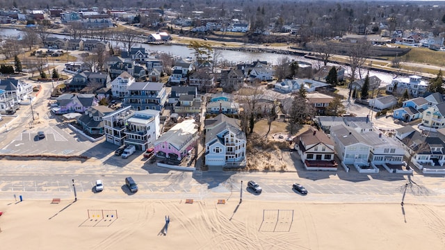 drone / aerial view with a water view and a residential view